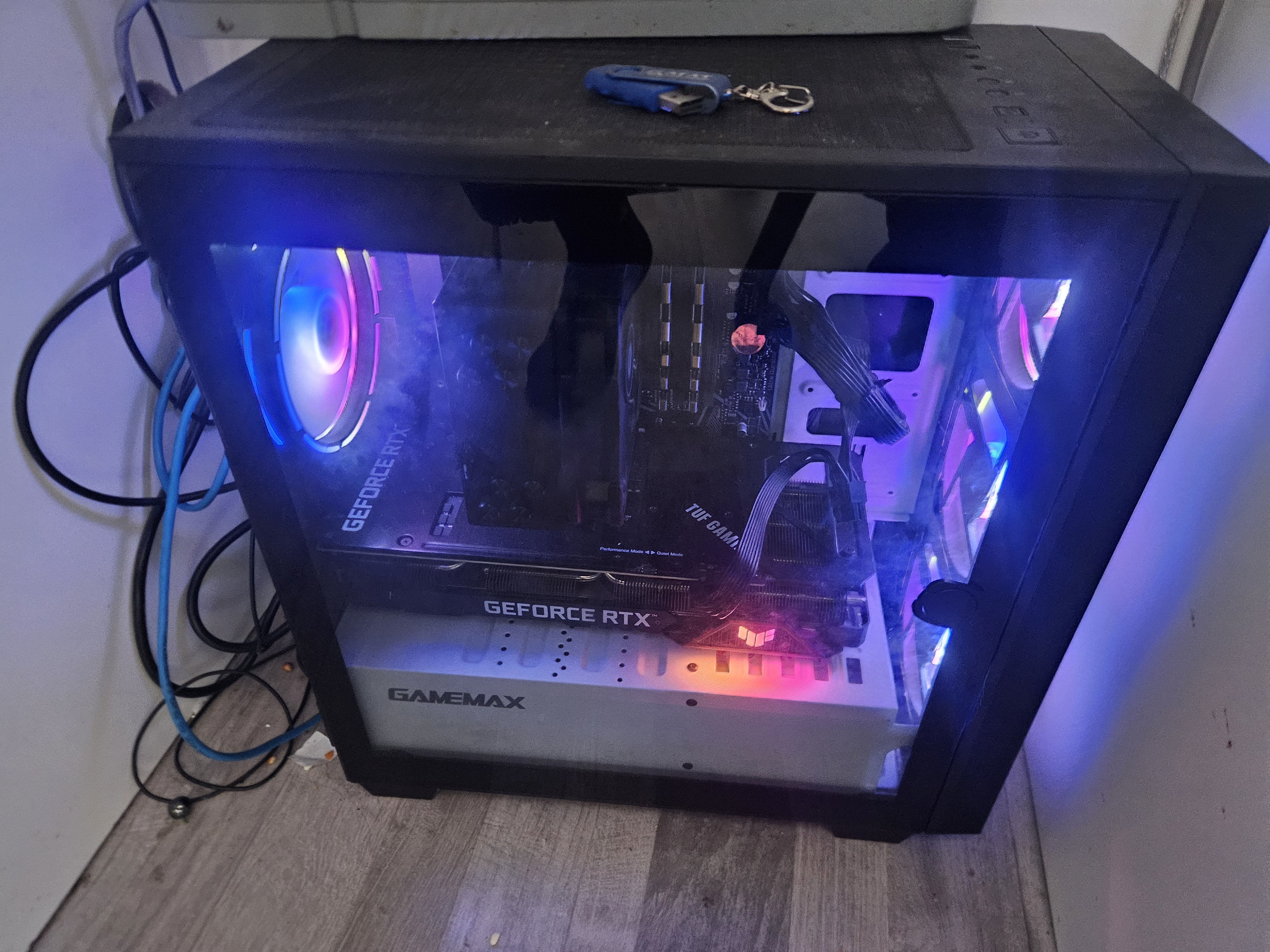 Photo of tim's pc, showcasing the front glass pane, behind which you can see a Geforce RTX and a few glowing fans.